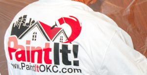 painter wearing a paint it okc shirt