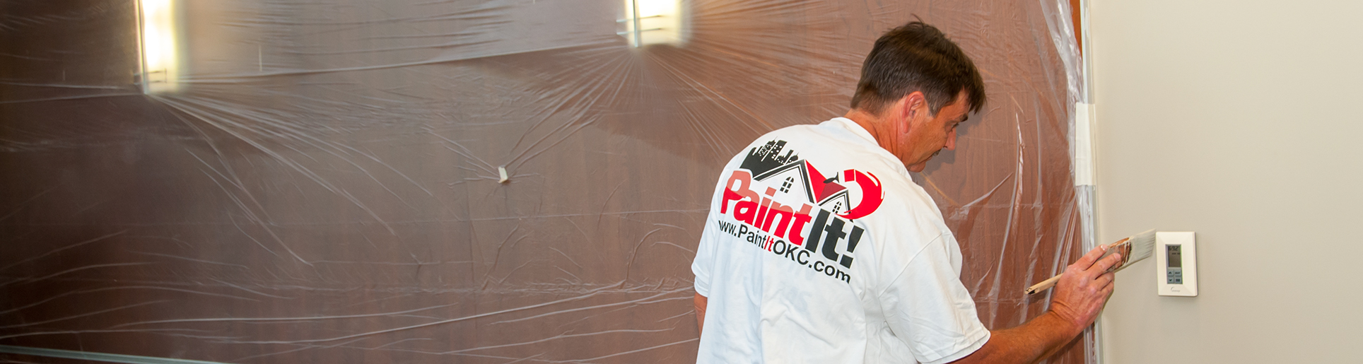 A house painter in Oklahoma City is painting walls for Paint It OKC.