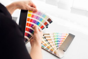 A Paint It OKC house painter is choosing a color of paint for painting a room.