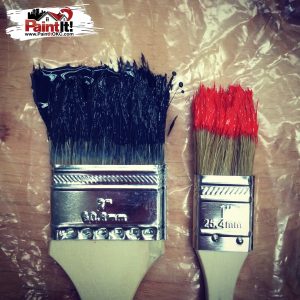 paint brushes covered in black and red paint