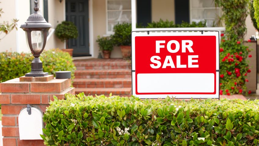 for sale sign in front of a home